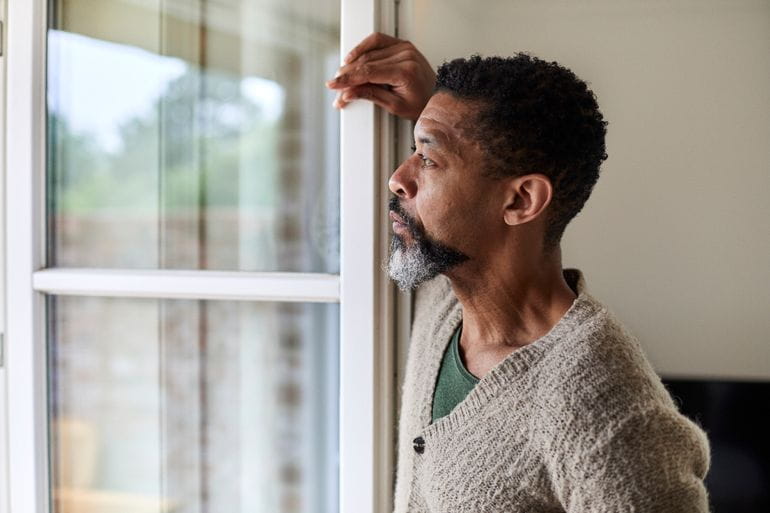Man looking out window 